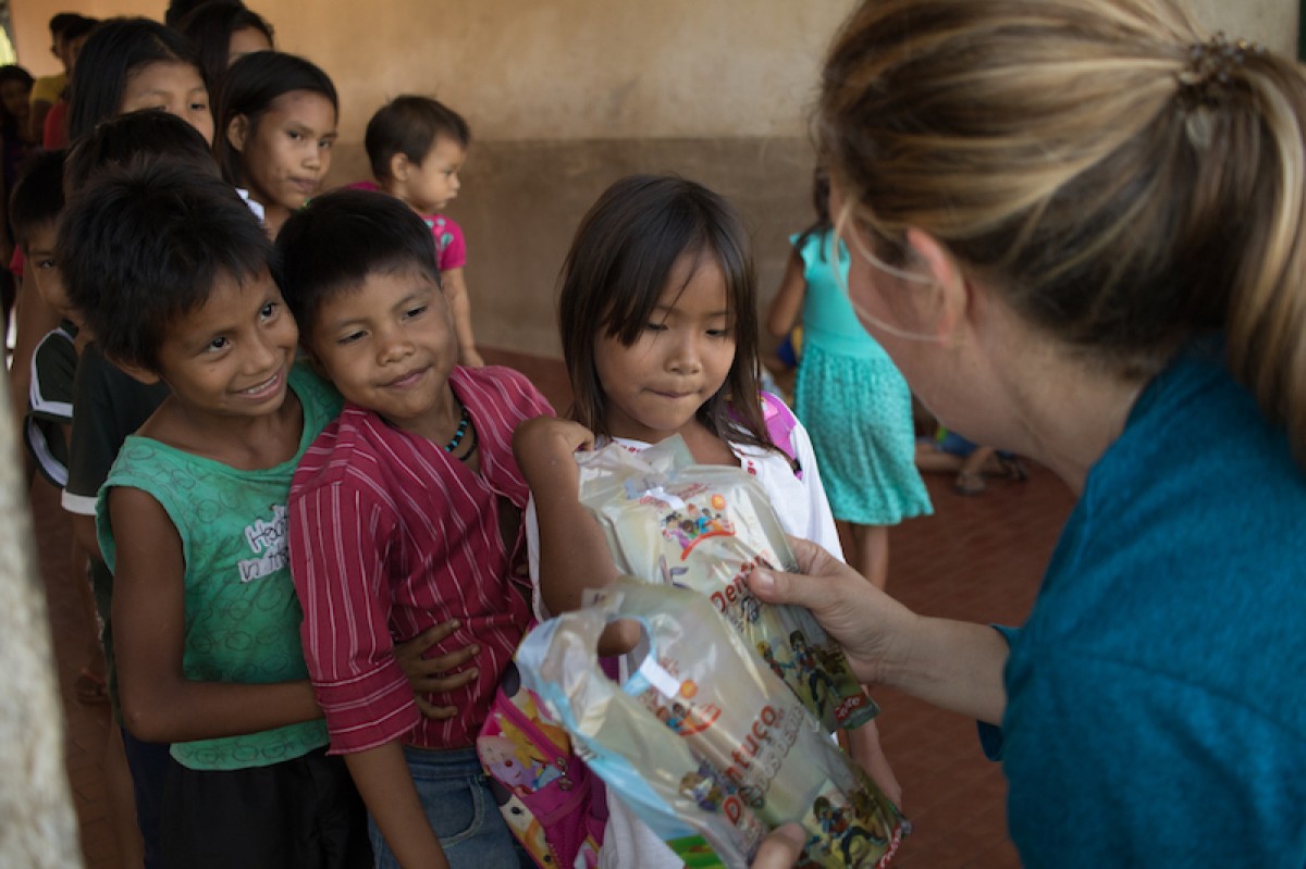 Children were given a set of dental care instruments and waited patiently for their own little pack.